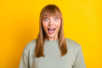 Wall Mural - Close-up portrait of nice charming amazed cheerful girl news reaction isolated over vibrant yellow color background