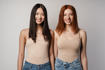 Wall Mural - Multiracial two women posing and smiling at camera