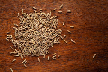 Wall Mural - Macro close-up of Organic cumin seed (Cuminum cyminum) or jeera on wooden top background. Pile of Indian Aromatic Spice. Top view