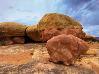 Sticker - Desert with yellow soil and big stones under a cloudy sky