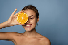 Happy Young Woman Holds Citrus To Her Face. Vitamin C Concept