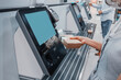 © EdNurg - Woman scans barcode of her lunch box for cashless payment at the self-service checkout in the supermarket. Such machines kiosks allows to increase throughput and reduce queue in the store