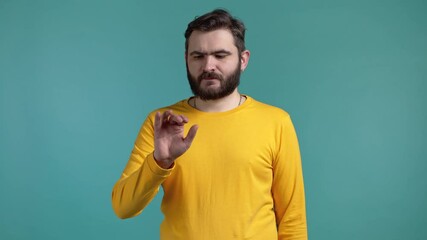 male using invisible touchscreen on blue studio background. he swiping, clicking, tapping on air scr