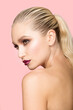 © Dragosh - Close-up portrait of beautiful young woman with perfect makeup and hair straightened, isolated light pink background.