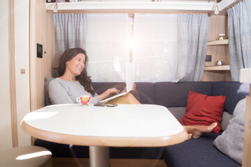 Poster - Spanish woman teleworking and communicating from her mobile office on a vacation at a campsite