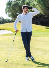 Poster - Young Caucasian male playing golf on a professional golf course