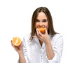 Cute young woman with sour face eats a sour orange. Isolated on white