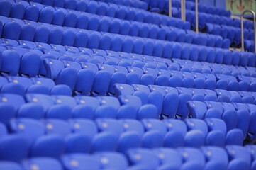 Wall Mural - The empty blue plastic seat at stadium.