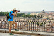 man traveler in a hat with a backpack and camera