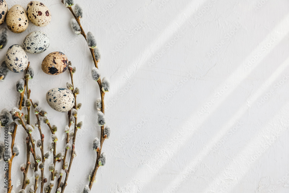 The beautiful easter composition of the willow branches and quail eggs ...