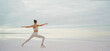 Panoramic view infinity salt lake and sky, sporty woman doing yoga exercise
