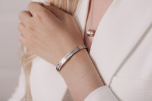 Woman Wearing Elegant Pendant Necklace And Bracelet On Close-up