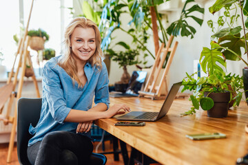 Comfortable office and woman indoors it with a laptop at table