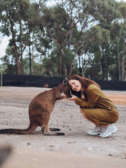 Wall Mural - Woman in the reserve is playing with a kangaroo