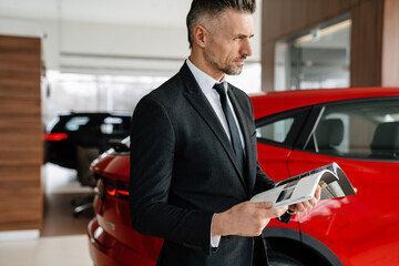 Sticker - Mid aged man choosing a new car