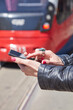 © astrosystem - Woman using cellphone on a tram station in Europe.