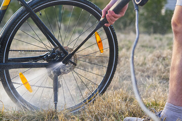 Bicycle washing on backyard. spring preparations for the cycling season. DIY bike care, pressure bike wash