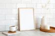 © photoguns - White picture frame mockup and home decor on table. Scandinavian living room interior design. Nordic style.