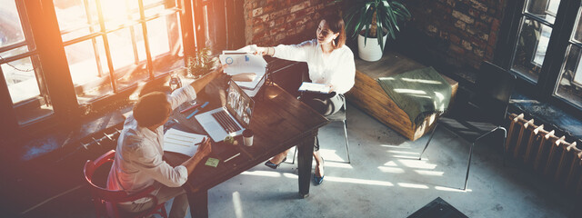 Wall Mural - Man and woman working together at the loft office