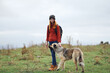 © SHOTPRIME STUDIO - woman hiker with a backpack in nature walks the dog in the mountains friendship travel