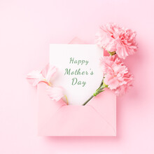 Happy Mother's Day Card In Pink Envelope With Carnations On Pink Background.