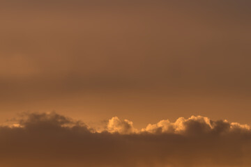 Beautiful evening sky with warm cocoa color clouds. Natural abstract background.