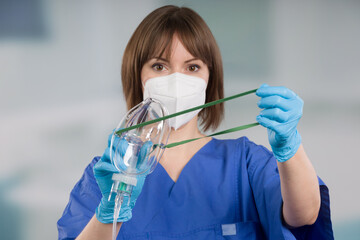 Wall Mural - nurse is applying disposable oxygen mask for breathing support from patient view