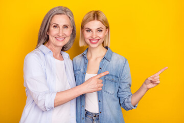 Sticker - Photo portrait of funky mother and daughter pointing fingers blank space recommending isolated bright yellow color background