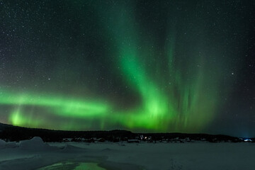reflection of the aurora borealis in the ice of the kolvitsa river in northern russia. sky with pola