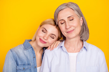 Sticker - Photo portrait of dreamy daughter and mother smiling spending free time together isolated vibrant yellow color background