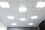 Fototapeta  - White ceiling with lighting in office room