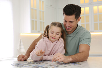 Poster - Man and his little daughter playing with puzzles at home