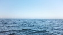 Windmill Park At Open Sea, Seen From A Far Distance. It Is A Beautiful, Clear, Sunny Spring Day. Filmed From A Boat. Location Is Øresund Between Copenhagen And Malmo. Slow Motion 4K