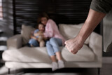 Fototapeta  - Man threatening his wife and daughter at home, closeup. Domestic violence