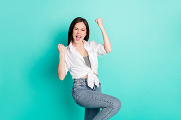 Poster - Photo of cheerful positive young woman lucky win raise fists celebrate isolated on pastel teal color background