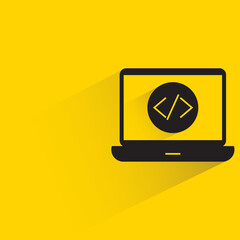 coding in laptop with shadow on yellow background