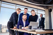 © Дмитрий Ткачук - Business, technology and office concept - happy business team with laptop computers, documents and coffee. Meeting before the start of the working day to discuss a business plan