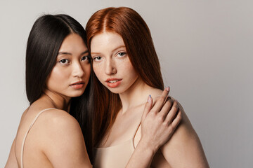 Wall Mural - Multiracial two women posing and looking at camera