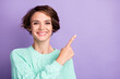 Photo of young happy positive smiling cheerful girl point finger copyspace advertisement isolated on violet color background