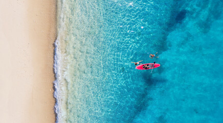 Wall Mural - kayaking. sup. aerial view of floating board and people on blue sea at sunny day. summer seascape. l