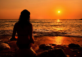 A lonely lady enjoying the sunset, at Lycodemus beach, Cythera (or 