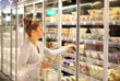 © lado2016 - Woman choosing a dairy products at supermarket
