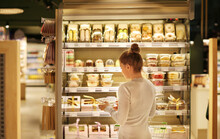Woman Choosing A Dairy Products At Supermarket