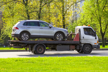 Hatchback car loaded onto a tow truck ready for transport.