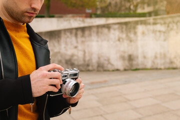 Young Hispanic tourist, taking pictures outdoors during his vacations or his honeymoon. lifestyle and travel concept.