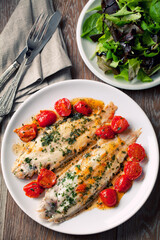 Wall Mural - Sole with cherry tomatoes on a plate. High quality photo.