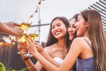 asian woman teenagers cheering and toast with white sparkling wine glass to celebrating at dinner pa