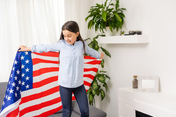 Cute little girl and USA flag on background