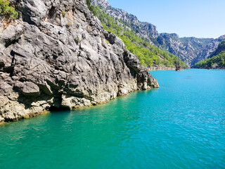 Wall Mural - Seascape against the backdrop of mountains on a cloudless sunny day.