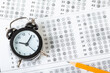© Nana_studio - alarm clock, optical form of standardized school test with bubble and black pencil, answer sheet, education concept